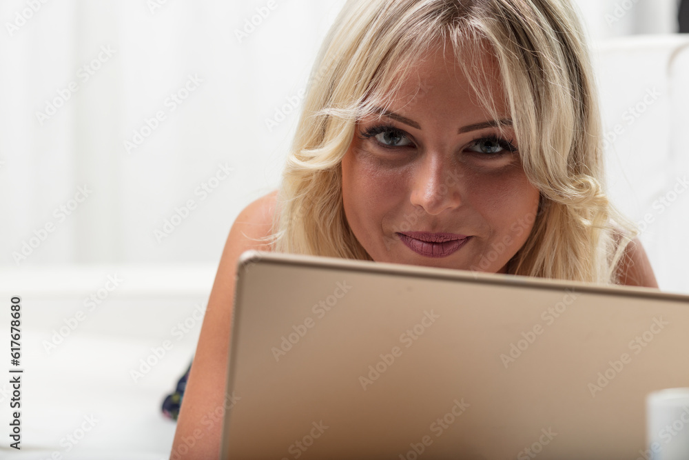 Woman with tablet, offering knowing, playful smile Woman with tablet, offering knowing, playful smile