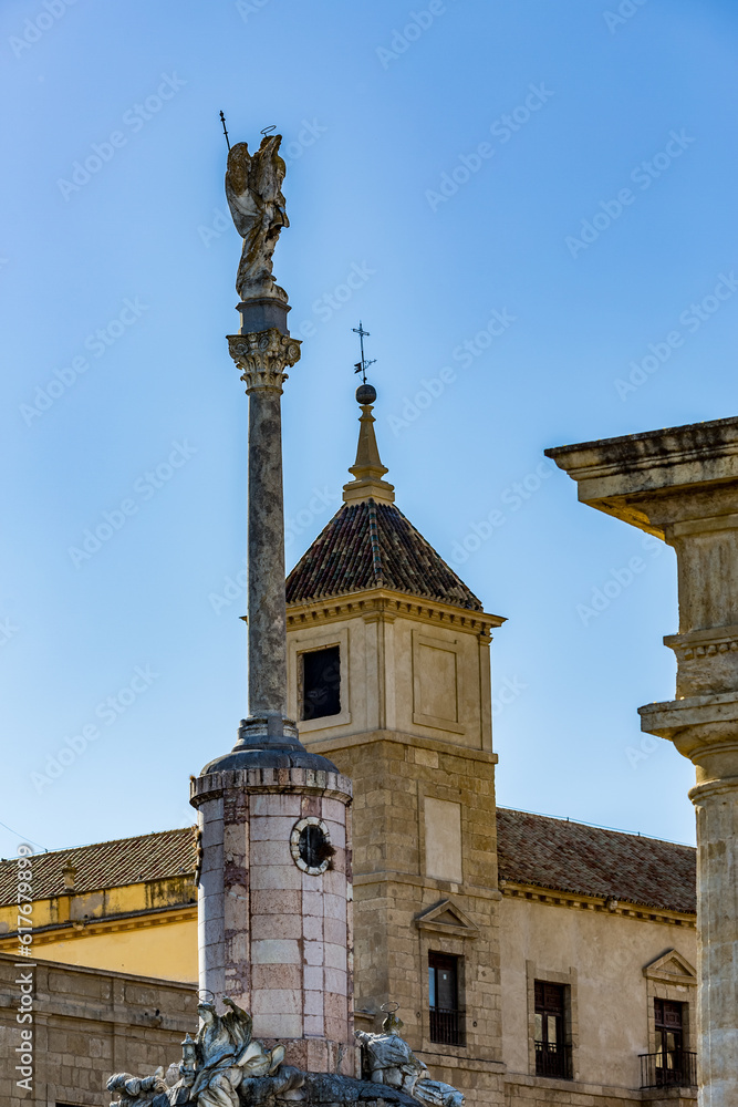 Statue on high pedestal next to church of St John the Baptist, Cordoba, Andalusia, Spain