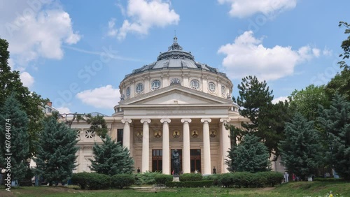 Romanian Athenaeum (Ateneul Roman), a landmark in Bucharest, Romania. Timelapse of white Summer clouds above this domed, circular concert hall building, opened in 1888.