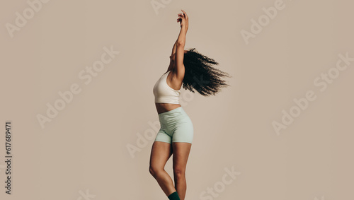 Fit young woman showing her flexibility and balance with a dance