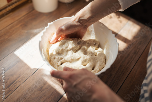 Photography Girl knead dough for baking bread in a plate