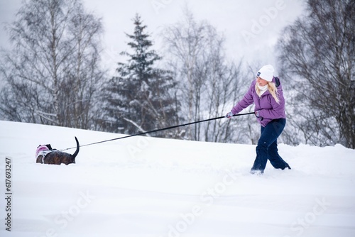 Woman with dog outside © Lucina/Wirestock Creators