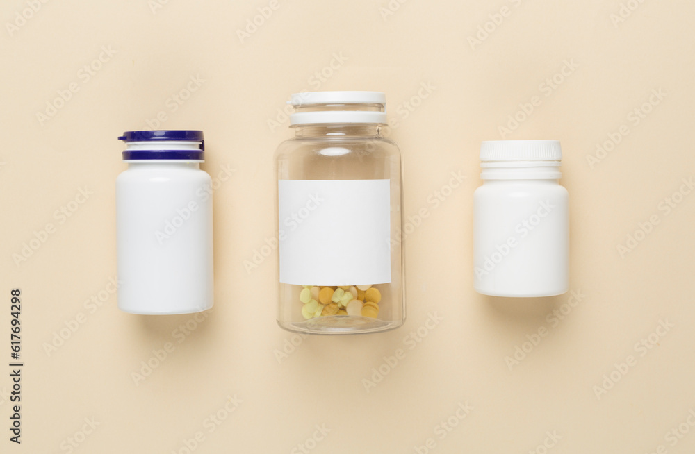 Plastic bottles with vitamins on color background, top view Plastic bottles with vitamins on color background, top view