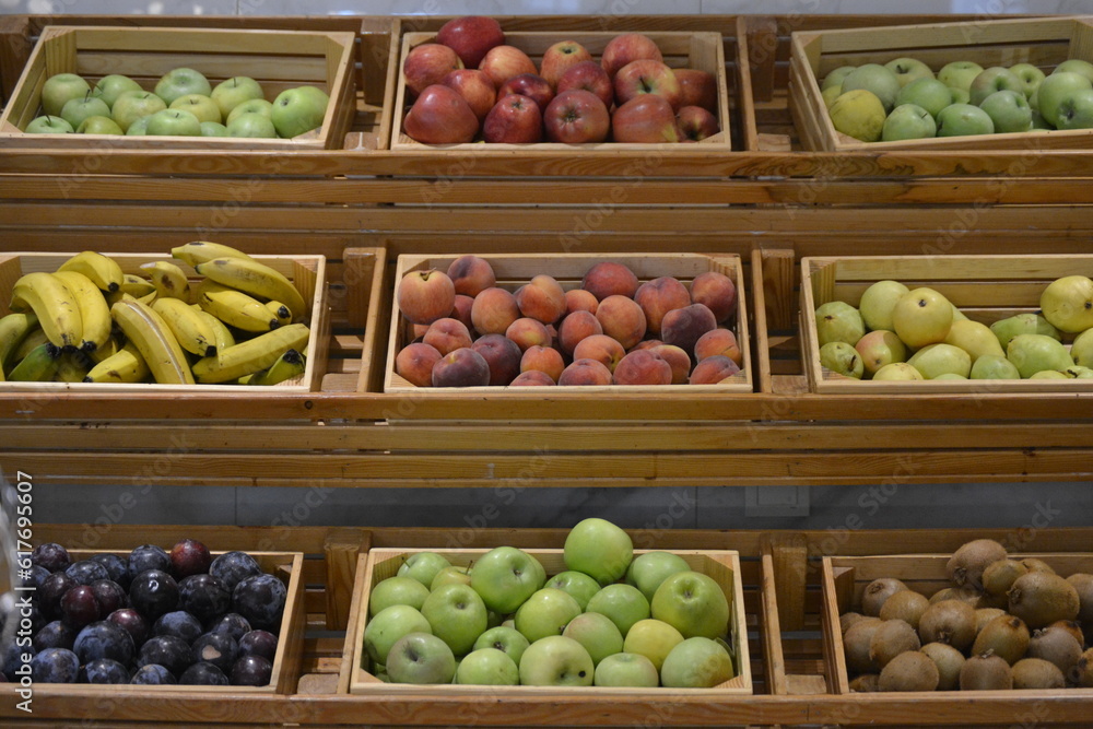 different types of fruit in boxes, apples, pears, bananas, kiwis etc.