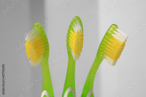 New toothbrushes on blurred background  closeup view