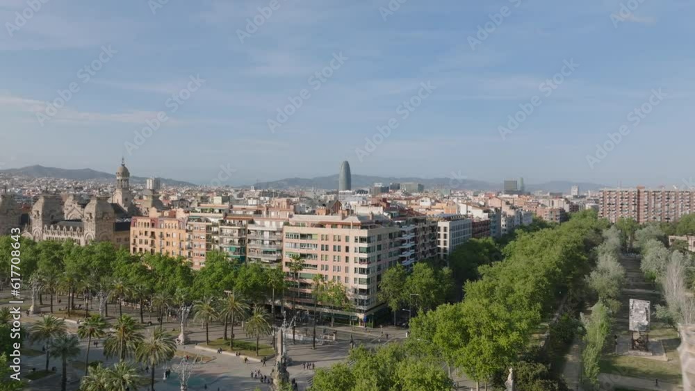 Forwards fly above city. Town park with palm trees and apartment buildings in urban borough. Barcelona, Spain Forwards fly above city. Town park with palm trees and apartment buildings in urban borough. Barcelona, Spain