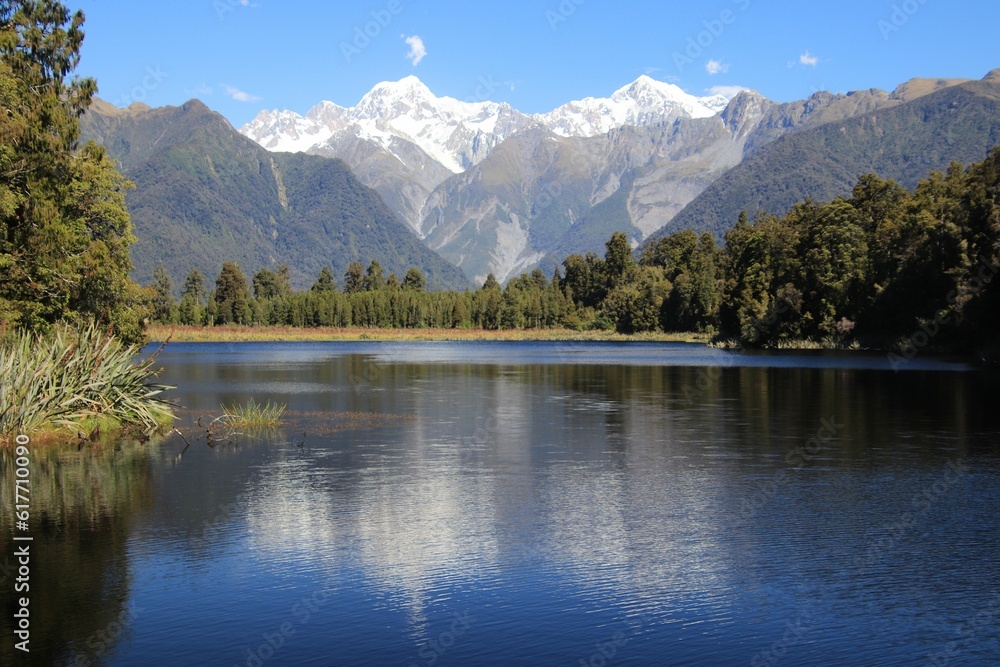 view of mountain range across the water in a lake at the base of a mountains