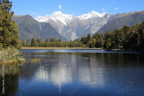 view of mountain range across the water in a lake at the base of a mountains