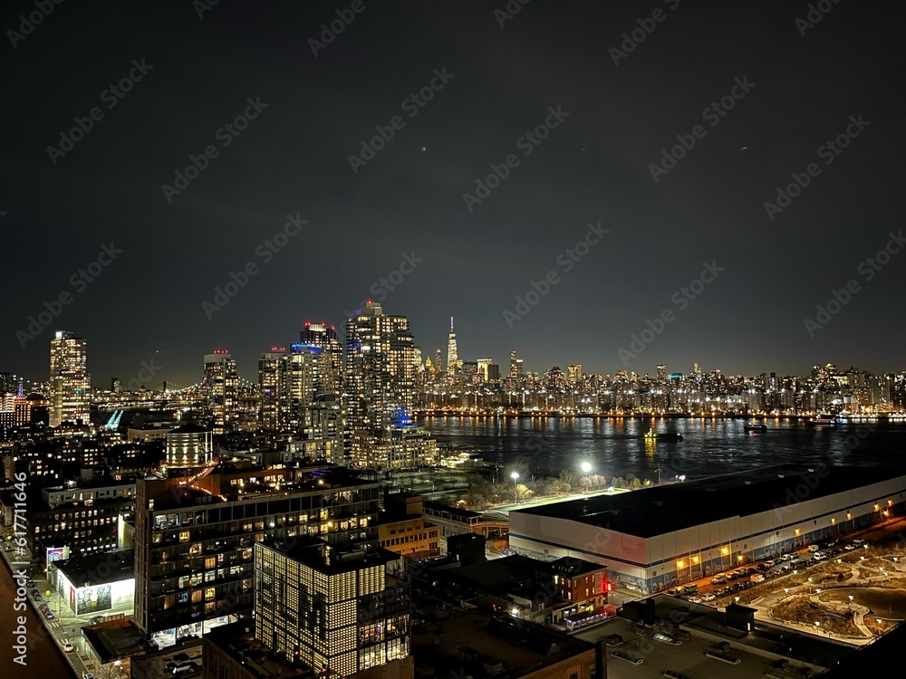 Stunning aerial view of a large city skyline illuminated with bright lights at night