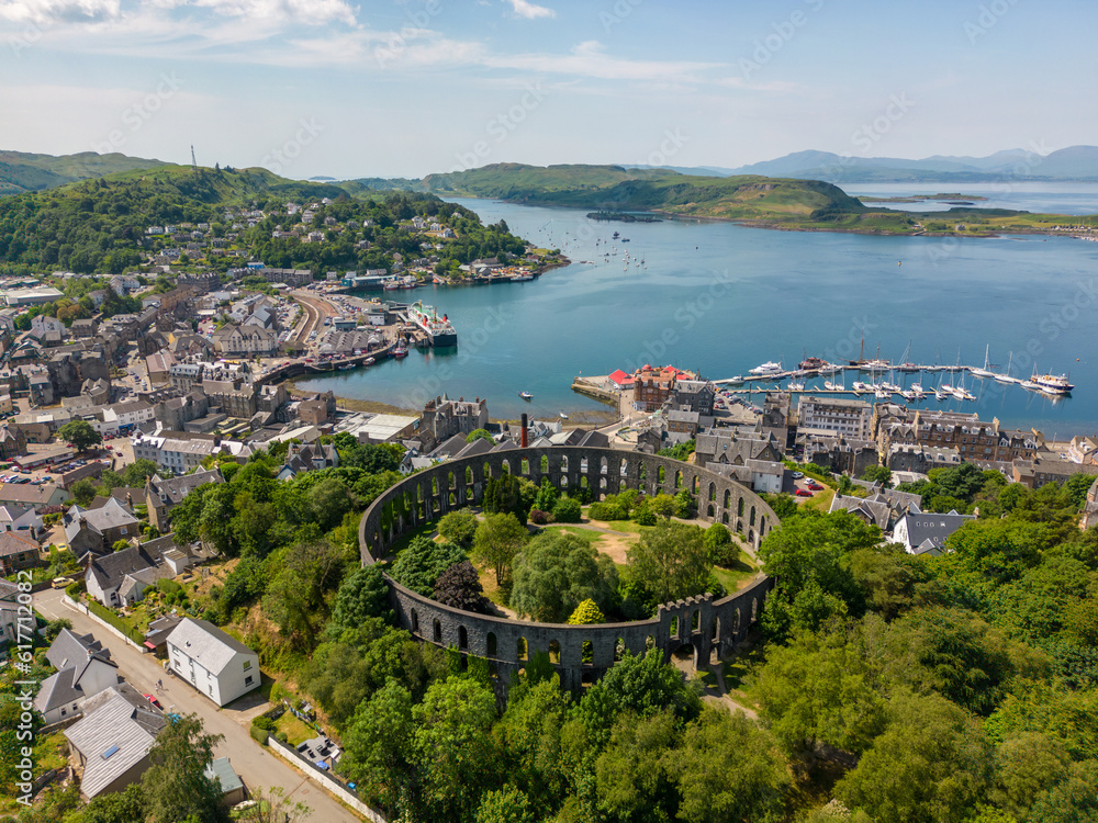 Drone photo of Mccraig's tower and the harbour town of Oban in Scotland.
