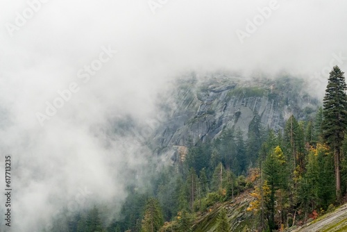 Picturesque landscape of majestic mountains shrouded in a layer of mysterious fog