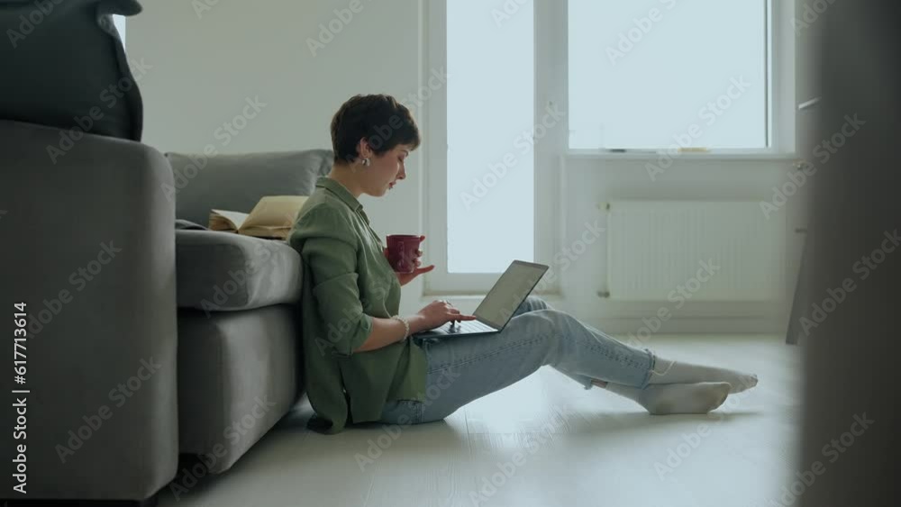 Serious female freelancer with piercings works on laptop from home. Remotely work Serious female freelancer with piercings works on laptop from home. Remotely work