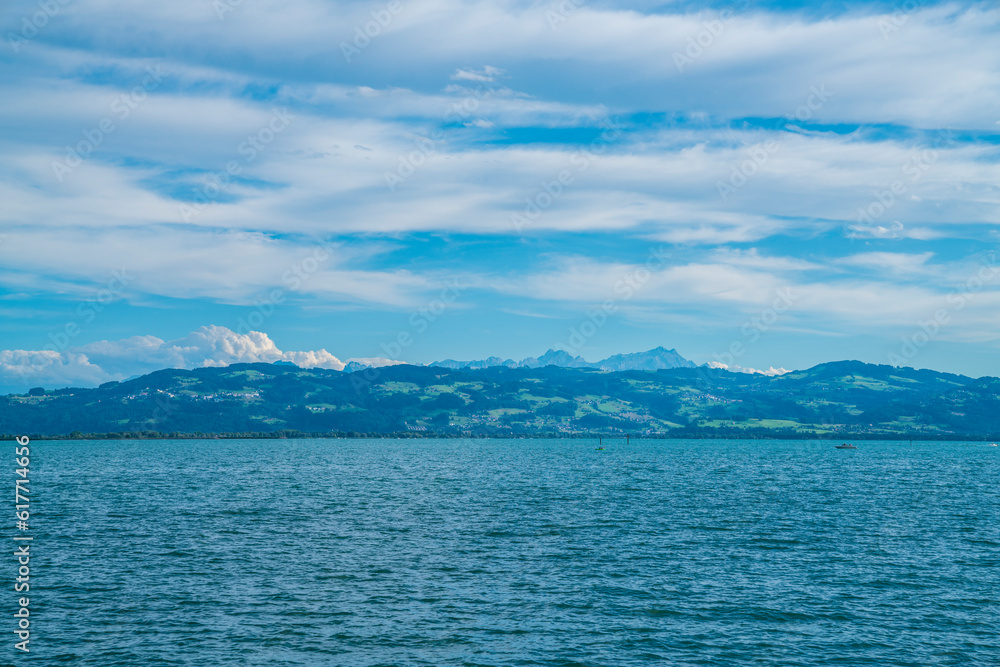 Germany, bodensee lake constance beautiful panorama view on sunny day into swiss alps mountains saentis and nature landscape