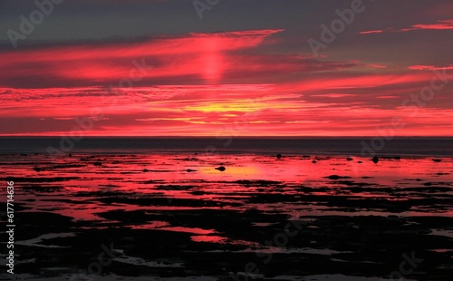 Spectacular sunset above the ocean  with vibrant oranges and pinks filling the sky above the horizon