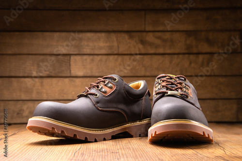 Stylish men's casual work boots for everyday walking in nature and the city on a wooden background stylish concept