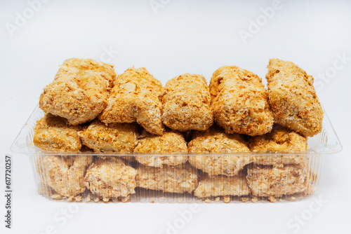 small sweet cupcakes with sprinkles on a white background. Napoleon cake cut into pieces on a light background. small cakes sprinkled with crumbs