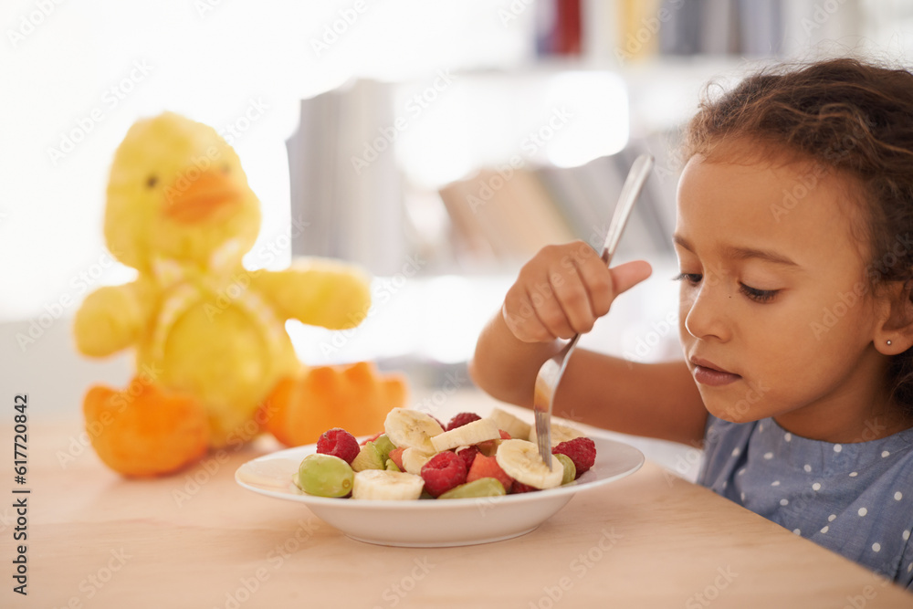 Eating child, morning and fruit salad at home with breakfast and wellness meal and vitamins. House, nutrition and young girl with healthy food and fruits of a hungry kid with youth at a table Eating child, morning and fruit salad at home with breakfast and wellness meal and vitamins. House, nutrition and young girl with healthy food and fruits of a hungry kid with youth at a table