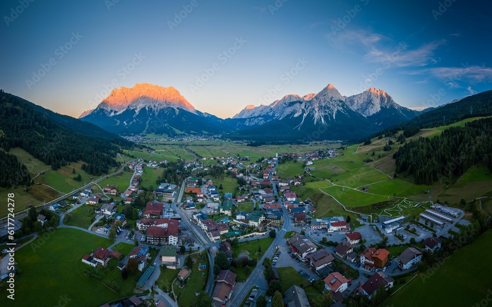Gartenposter mit Picturesque mountain village situated in a lush valley surrounded by verdant hills, Lermoos, Tirol #617724278