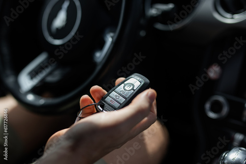 Tableau sur toile Key car fob female hand holding steering wheel travel explore open unlock opport