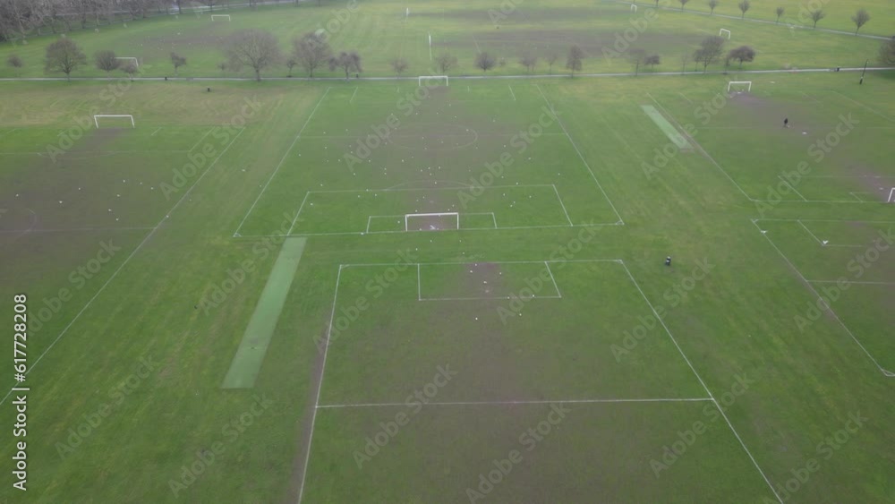 Drone view over open soccer fields with trees and grass meadow fields Drone view over open soccer fields with trees and grass meadow fields