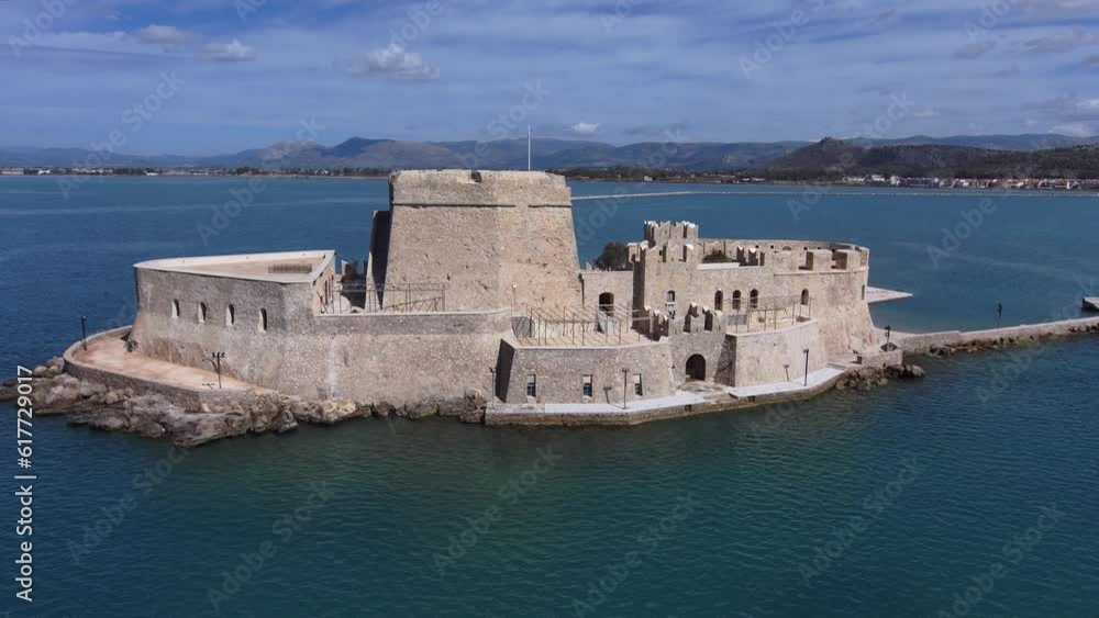 Aerial of the medieval Bourtzi Castle in Nafplio, Greece surrounded by the sea Aerial of the medieval Bourtzi Castle in Nafplio, Greece surrounded by the sea