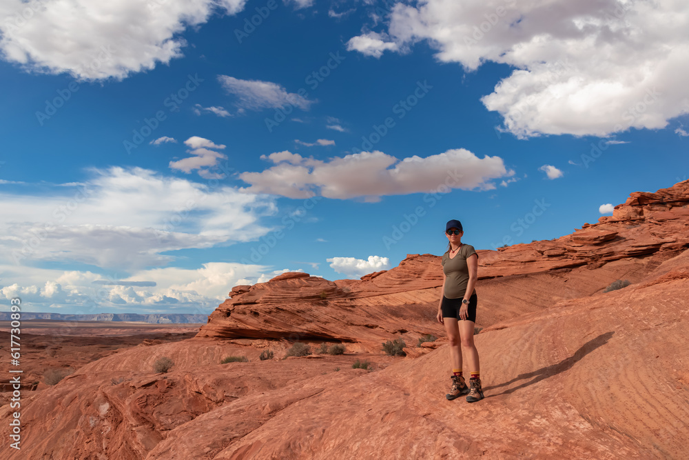 Tourist woman with scenic view of geological rock formations near Horseshoe bend of Colorado river near Page, Arizona, USA United States of America. Sandstones in Glen Canyon National Recreation Area