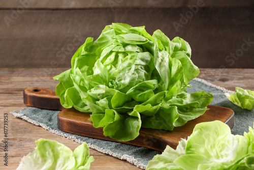 Fresh green butter lettuce on wooden table, closeup