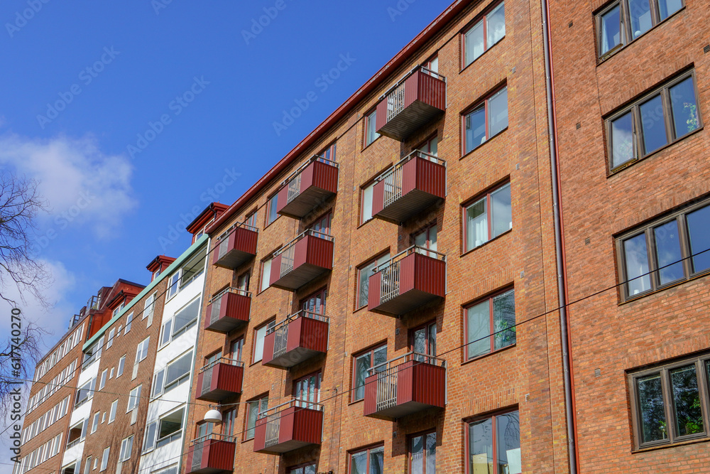 Detailed view of brick facade with fenced balconies of large apartment building in city center of Gothenburg, Sweden.