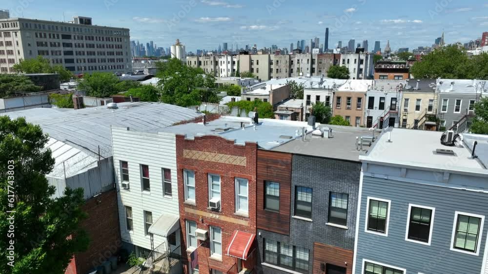 Aerial rising shot of neighborhood In Brookyln District with Industry City and Skyline of NYC in background - Establishing drone panorama view Aerial rising shot of neighborhood In Brookyln District with Industry City and Skyline of NYC in background - Establishing drone panorama view