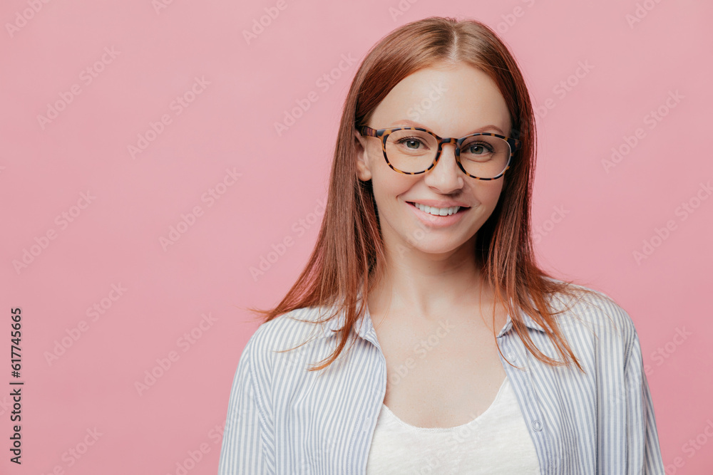 Happy entrepreneur, straight hair, spectacles, positive smile. Good sales, profits. Stylish shirt. Pink background. Copy space for text.