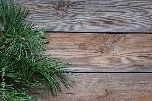 Branches of a Christmas tree (pine)on wooden background. Christmas and New Year, Winter holidays concept. Top view and copy space.