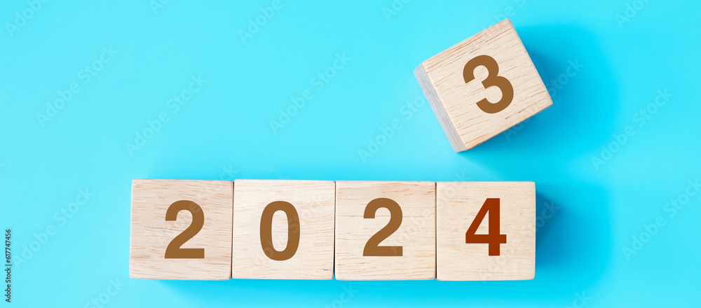 wooden cube block with 2024 text on blue background. Resolution, plan, review, goal, start and New Year holiday concepts wooden cube block with 2024 text on blue background. Resolution, plan, review, goal, start and New Year holiday concepts