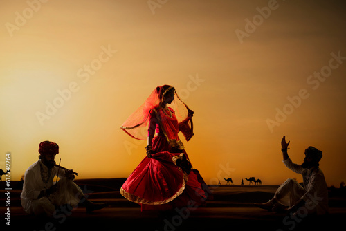 Rajasthani dance troupe performing in desert at sunset