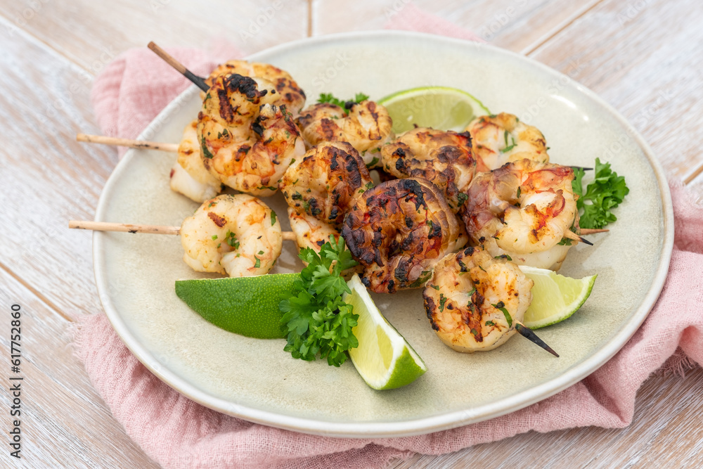 Grilled shrimp skewers. Seafood, shelfish. Shrimps Prawns skewers with lime. Barbecue srimps prawns.