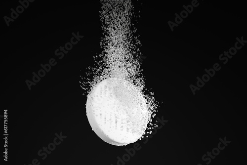 Dispersible aspirin sinking and dissolving into clear water on black background. Illustration of the concept of soluble pills and pharmaceutical industry