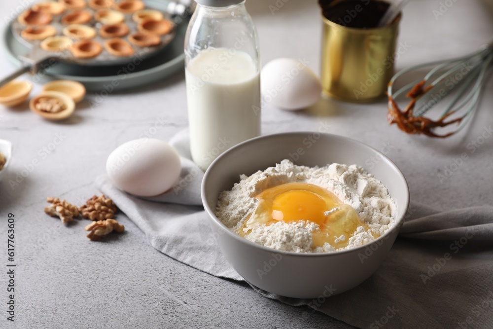 Fresh ingredients for preparing walnut shaped cookies on light grey table. Space for text Fresh ingredients for preparing walnut shaped cookies on light grey table. Space for text