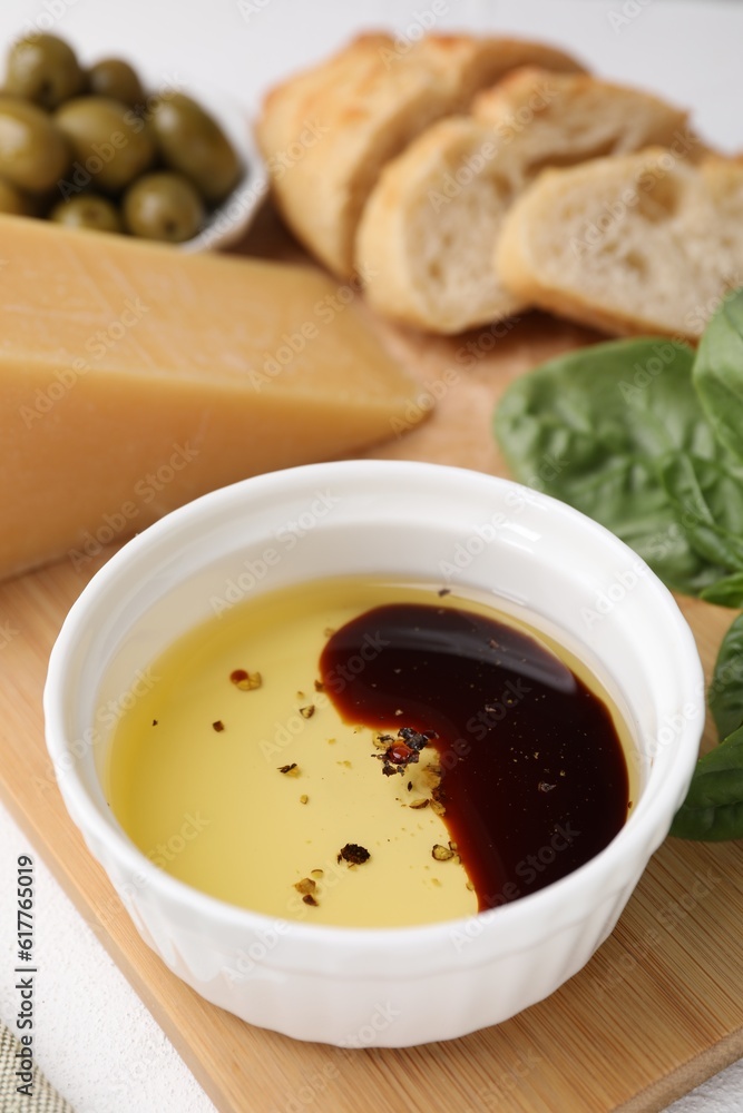 Bowl of organic balsamic vinegar with oil, basil and other products on table Bowl of organic balsamic vinegar with oil, basil and other products on table