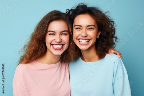 Two fit young women stand together in sportswear, embracing a healthy lifestyle in the studio clean background. Generative AI