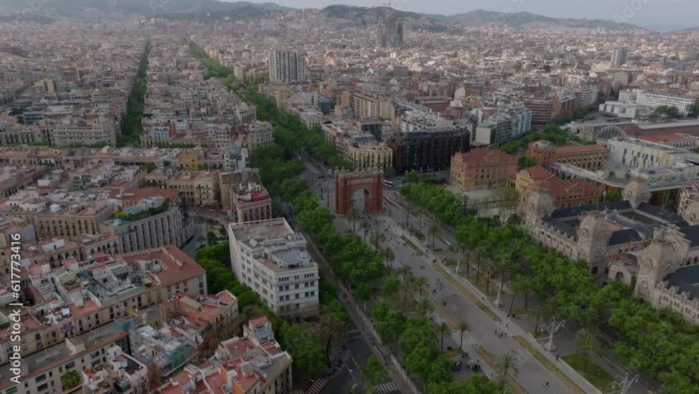 Aerial view of park with rows of palm trees, Arc de Triomf landmark and wide boulevard. Metropolis cityscape. Barcelona, Spain Aerial view of park with rows of palm trees, Arc de Triomf landmark and wide boulevard. Metropolis cityscape. Barcelona, Spain