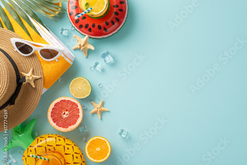 The perfect summer getaway with sunglasses, cocktails, towel, hat. Top view flat lay on blue background with copyspace for text or advert