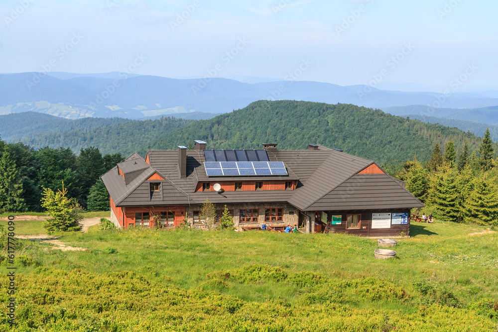 Mountain tourist shelter on Hala Łabowska with a view of the surrounding peaks in Beskid Sadecki, Poland