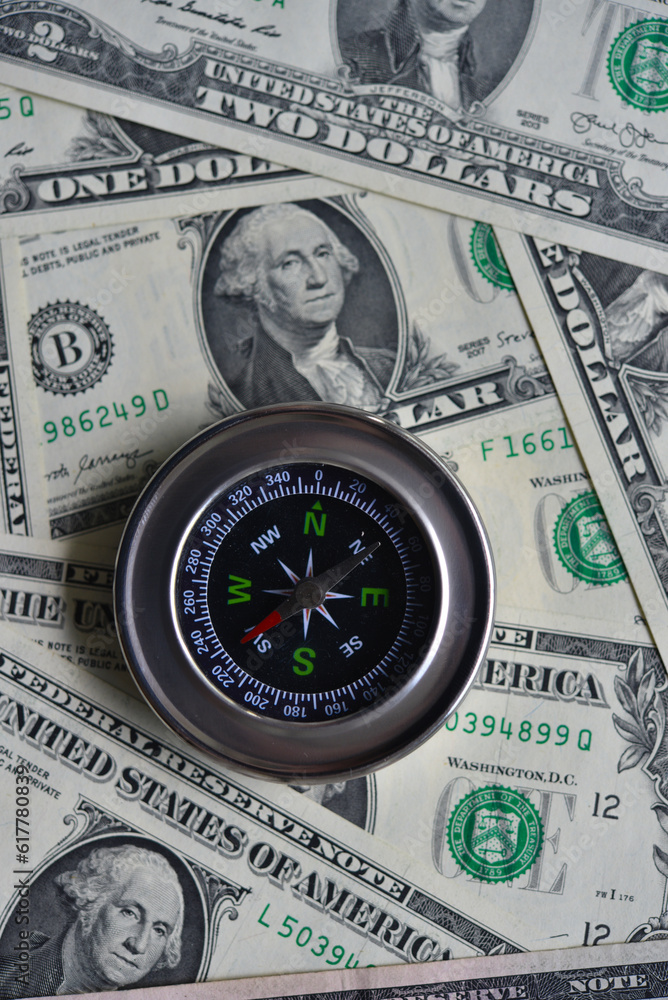 Compass and banknotes. US dollars. Navigation in the financial world. Compass and banknotes. US dollars. Navigation in the financial world.