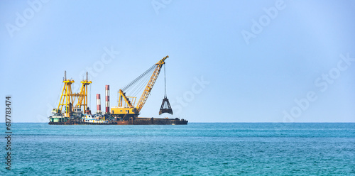 Floating dredging platform in the sea Dredger working photo