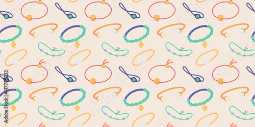 Seamless pattern with various bracelets on a beige background.