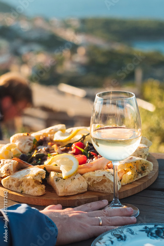 Obraz na płótnie Luxury seafood board and a glass of wine with amazing sea view of Kvarner bay and Lošinj archipelago of Croatia islands w salonie