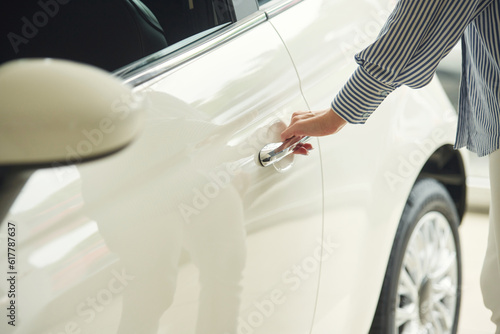 Opening the door. Close up view of woman that is with electric car