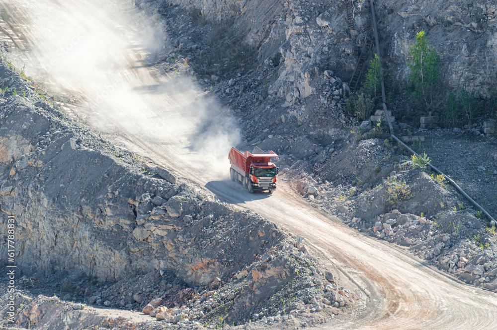 Heavy Dump Truck Rides on a Industrial Terraces of the Open Pit Mineral Mine Heavy Dump Truck Rides on a Industrial Terraces of the Open Pit Mineral Mine