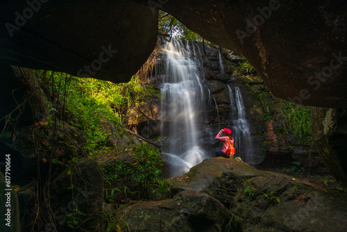Tableau sur toile Young woman hiking on beautiful waterfall in Phu Wiang National Park, Tad Fah waterfall, Khon Kaen  province, ThaiLand