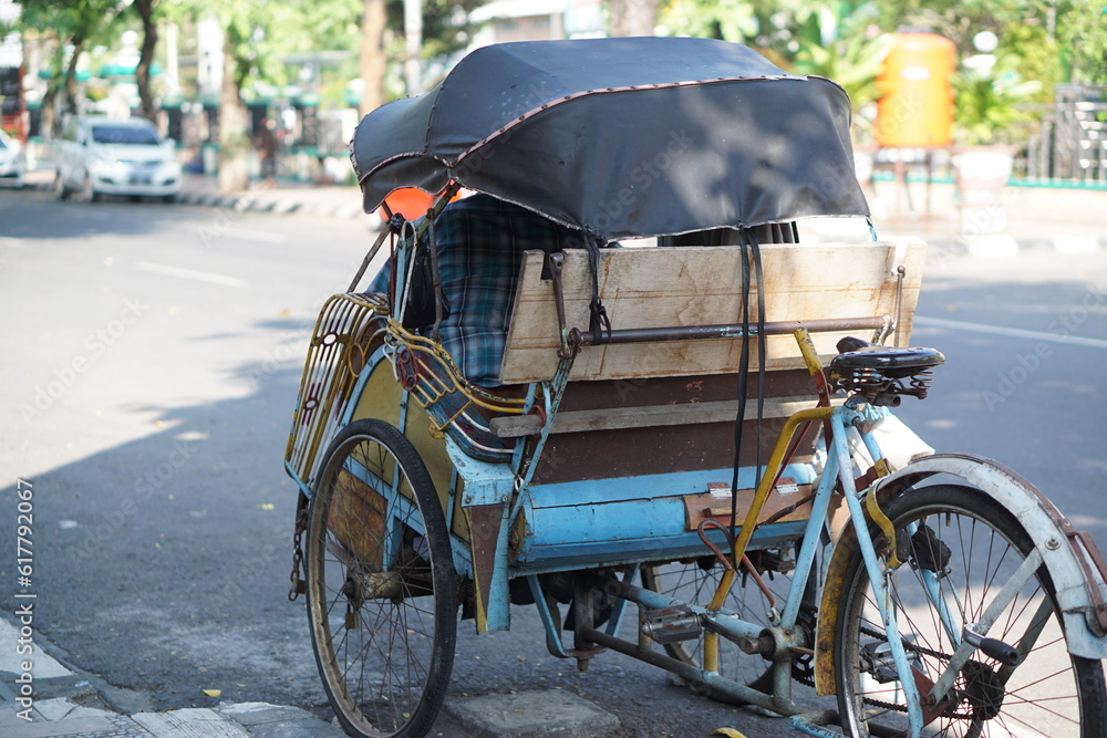 Surakarta, Indonesia -05 May 2023; Becak is a traditional means of transportation, tourist transportation which is still active in the city of Solo.