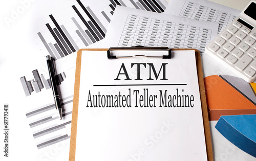 Paper with ATM on a chart background, business photo